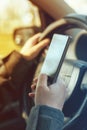 Driving car and using mobile phone to send text message Royalty Free Stock Photo