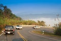 Driving on curve road in the mountain with the sea mist and blue sky and forest, country road in north of Thailand