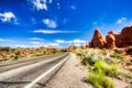 Driving through the-Desert with Monument Rock along the Road During Sunny Day, Arches NP