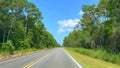 Driving down highway 30A near Rosemary Beach, Florida USA with Golf Carts and Cars going by