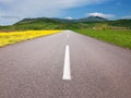 Driving on an empty asphalt road through the idyllic fields Royalty Free Stock Photo