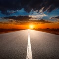 Driving on an empty asphalt road at sunset Royalty Free Stock Photo