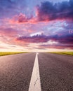 Driving on an empty asphalt road at sunset