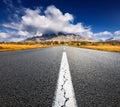 Driving on an empty asphalt road to the mountains Royalty Free Stock Photo