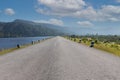 Driving on an empty road. Empty asphalt road through the green field and clouds on blue sky in summer day. Open road ahead, endles Royalty Free Stock Photo