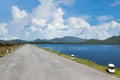 Driving on an empty road. Empty asphalt road through the green field and clouds on blue sky in summer day. Open road ahead, endles Royalty Free Stock Photo