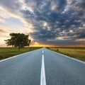 Driving on an empty road at sunrise