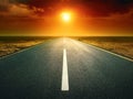 Driving on an empty road at sunset Royalty Free Stock Photo
