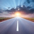 Driving on an empty road towards the rising sun Royalty Free Stock Photo