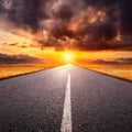 Driving on an empty road towards the setting sun Royalty Free Stock Photo