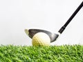 Driving the golf ball with the driver on artificial grass and white background Royalty Free Stock Photo
