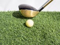 Driving the golf ball with the driver on artificial grass and white background Royalty Free Stock Photo