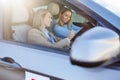 Driving Instructor Explaining Evaluation Sheet to Learner Driver. Royalty Free Stock Photo