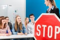 Driving instructor holding theoretical part of driving lessons