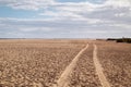 Driving Lanes in the sand on the wide beach of Jandia, under cloudy skies Royalty Free Stock Photo