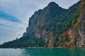 Driving Longtailboat on Khao Sok Lake in Thailand within beautiful rocky landscape