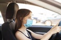 Driving in mask, woman taxi driver at the wheel in protection from covid-19, health and medical safety, safe service for