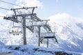 The driving mechanism of the lift high in the mountains on a clear day against the background of a blue sky. Winter sports and