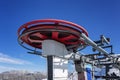 The driving mechanism of the lift high in the mountains on a clear day against the background of a blue sky. Winter sports and