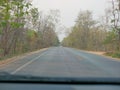 Driving through mixed deciduous forest, typical scenery seen during a long drive in Thailand - driver`s perspective / point of