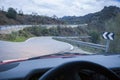 Driving by narrow mountain curvy road at sunset Royalty Free Stock Photo