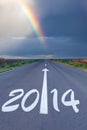 Driving om empty road under the rainbow Royalty Free Stock Photo