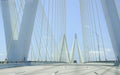Driving over large cable suspension bridge, with a clear view of the cables and supports and M shaped structure.
