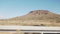 Driving plate side view moving through desert in car with motion blur