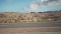 Driving plate side view moving through desert in car with motion blur
