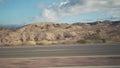 Driving plate side view moving through desert in car with motion blur