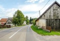 Driving on a Provincial Road through Villages in Croatian Countryside. Rural Scenery with Green Trees and Old Cottages Royalty Free Stock Photo