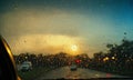 Driving on a rainy day through the windshield of a car.