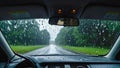 Driving on rainy road with rain drops on windshield Royalty Free Stock Photo