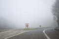 Poor weather conditions. Exit from the highway, badly seen sign ahead; Royalty Free Stock Photo