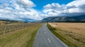 Driving on a rural country road through agricultural farmland in a rural valley