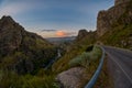 Driving scenic mountain road at sunset