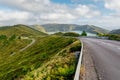 Driving scenic winding road with mountain landscape and Lagoa do Fogo in the background. Royalty Free Stock Photo