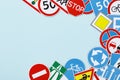 Driving school banner. Flat lay road signs and traffic symbols on color background Royalty Free Stock Photo