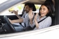 Frightened millennial woman driving car with instructor Royalty Free Stock Photo