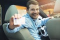 Driving school - man sitting inside the car and showing his driver license Royalty Free Stock Photo