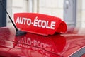 Driving school means auto ecole text in french write on education learning car roof Royalty Free Stock Photo