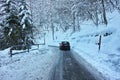 Driving on slippery snowy road in alpine region Royalty Free Stock Photo