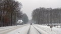 Driving in a snowstorm on a countryroad in the Netherlands in winter Royalty Free Stock Photo