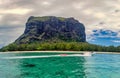 A driving speed boat in front of the popular Le Morne Brabant mountain of the african dream island Mauritius. Royalty Free Stock Photo