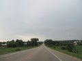 Driving on a Straight Flat Road, Wisconsin Highway in Summer Rain Royalty Free Stock Photo