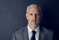 Driving success with the right mindset. Studio portrait of a mature businessman against a dark background.