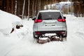 Driving SUV car in winter on forest snow road Royalty Free Stock Photo