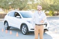 Driving Teacher Smiling Against Car