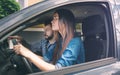 Driving test. Young serious woman driving car feeling inexperienced, looking nervous at the road traffic for information Royalty Free Stock Photo