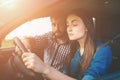 Driving test. Young serious woman driving car feeling inexperienced, looking nervous at the road traffic for information Royalty Free Stock Photo